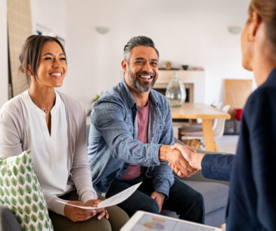 Multiethnic couple handshake with consultant at home
