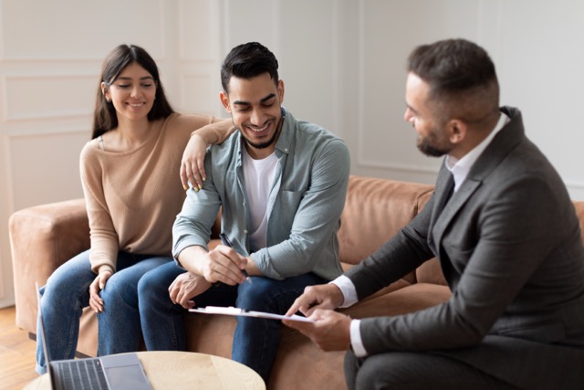Real Estate Agent Showing Buyers Contract, Man Signing Real Estate Agent Showing Buyers Contract, Man Signing