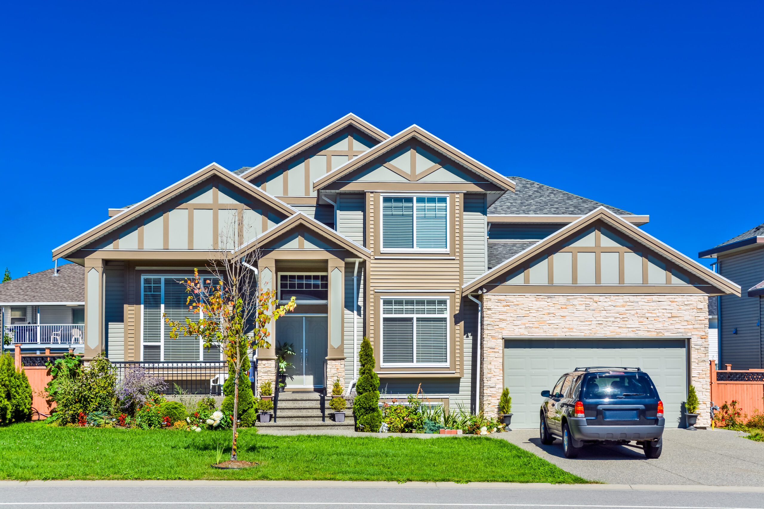 Brand new residential house with car parked on driveway in front